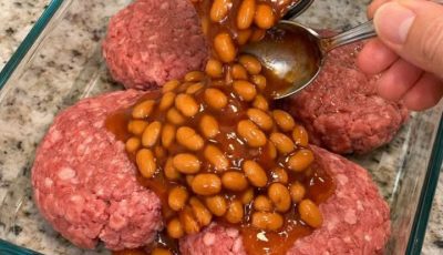 Pour sweet baked beans over raw ground beef patties, alongside 3 ingredients, into a glass baking dish for a savory meal that’s always a yes in my h